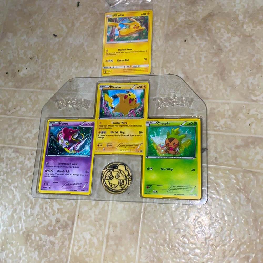 Black star Promo Hoopa, Pikachu and Chespin. Along with enclosed Pikachu promo